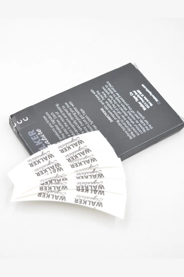 Close-up of the clear adhesive side of the tape with red liner peeled back