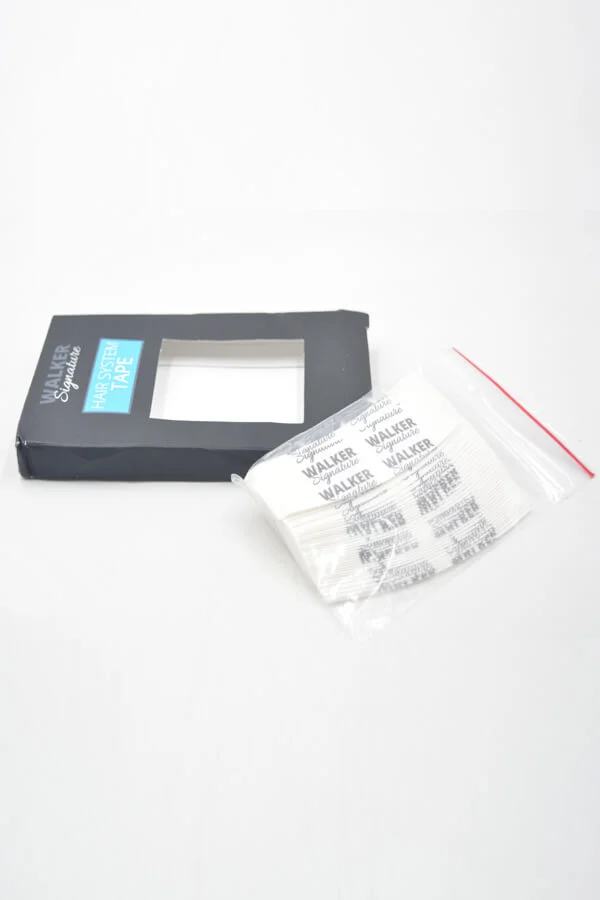 Tape applied to a poly-based hair system base, showing the thin, clear finish