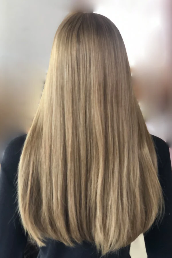 Side view of the Mona 4x4 lace top wig showing the hand-tied hairline and natural straight texture