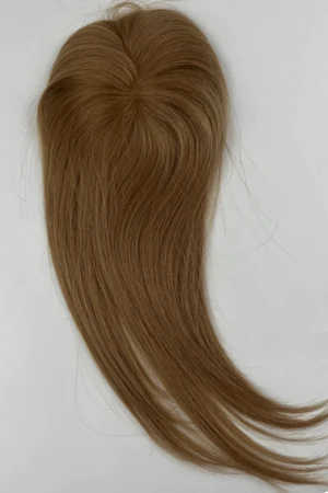 SALIS hair topper styled on a woman's head showing the front parting and natural blend
