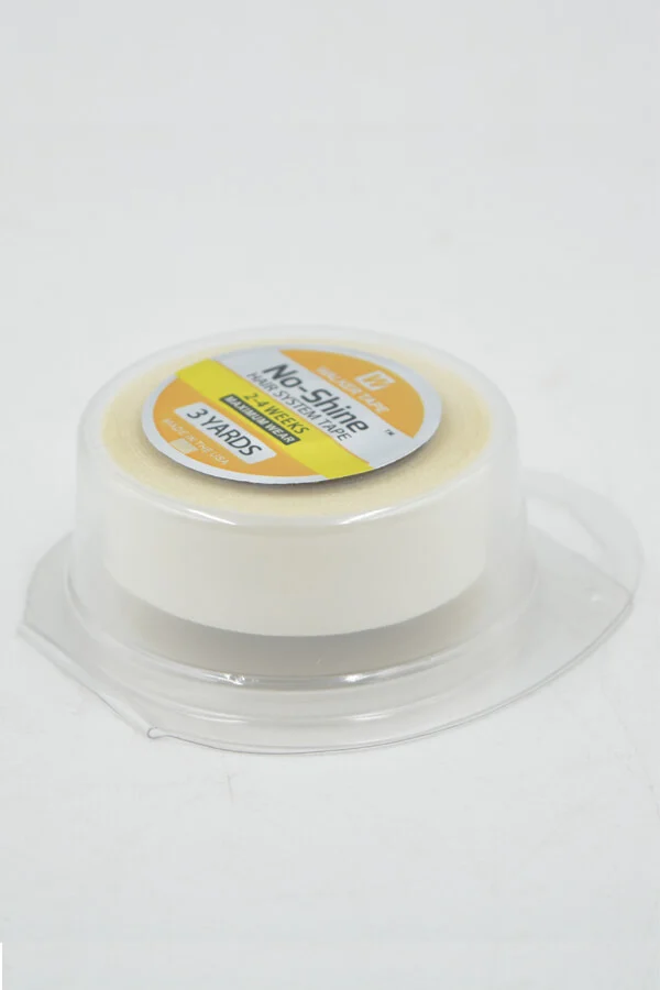Tape applied to the scalp with a hair system being positioned over it, showing seamless integration