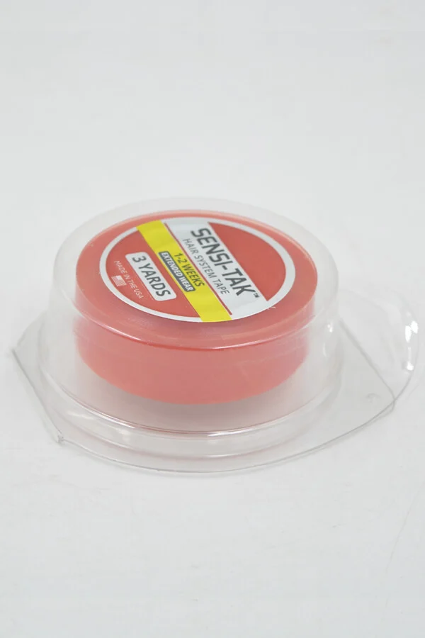 Roll of SENSI-TAK tape laid flat with backing tape visible, showing the adhesive side