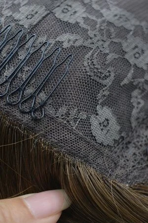 Front view of the SAURA topper styled on a mannequin head with natural parting