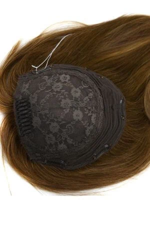 SAURA topper worn on a woman's head, showing natural blending with the scalp and hairline