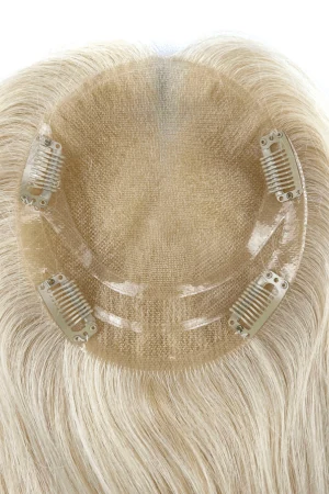 ELGN topper styled on a mannequin head showing the front parting and natural fall