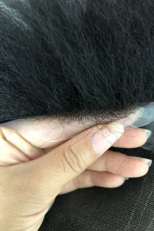 YHSL toupee styled on a mannequin head showing the natural hairline and parting