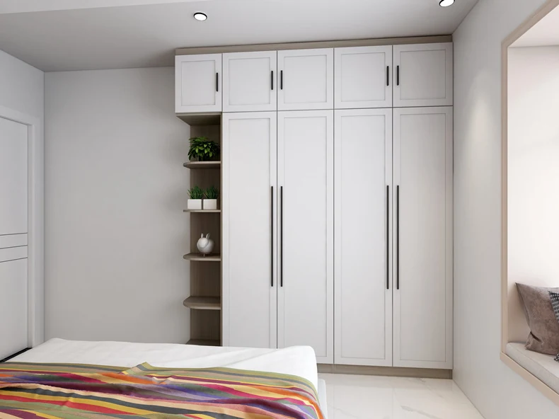 Fitted white bedroom wardrobe run in a finished apartment