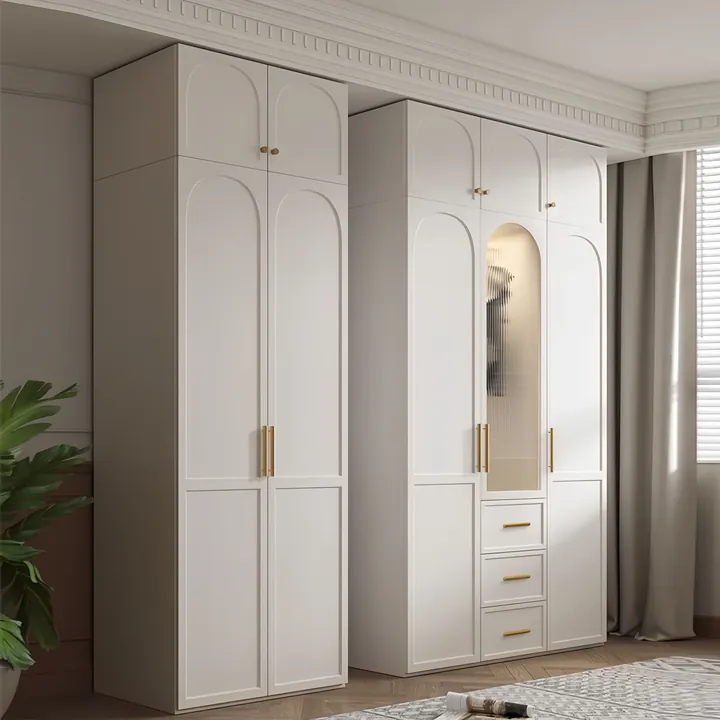 Cream wardrobe with arched door panels a full length mirror door and slim gold handles
