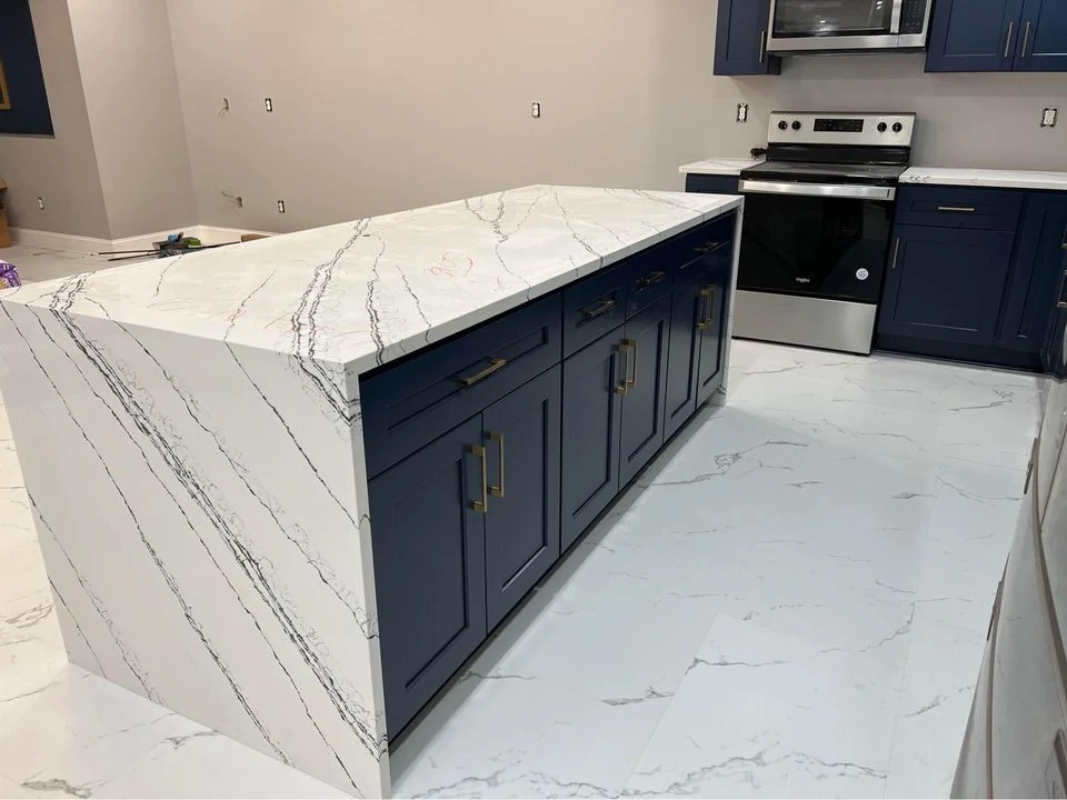 Shaker kitchen with a stone island and full height wall units