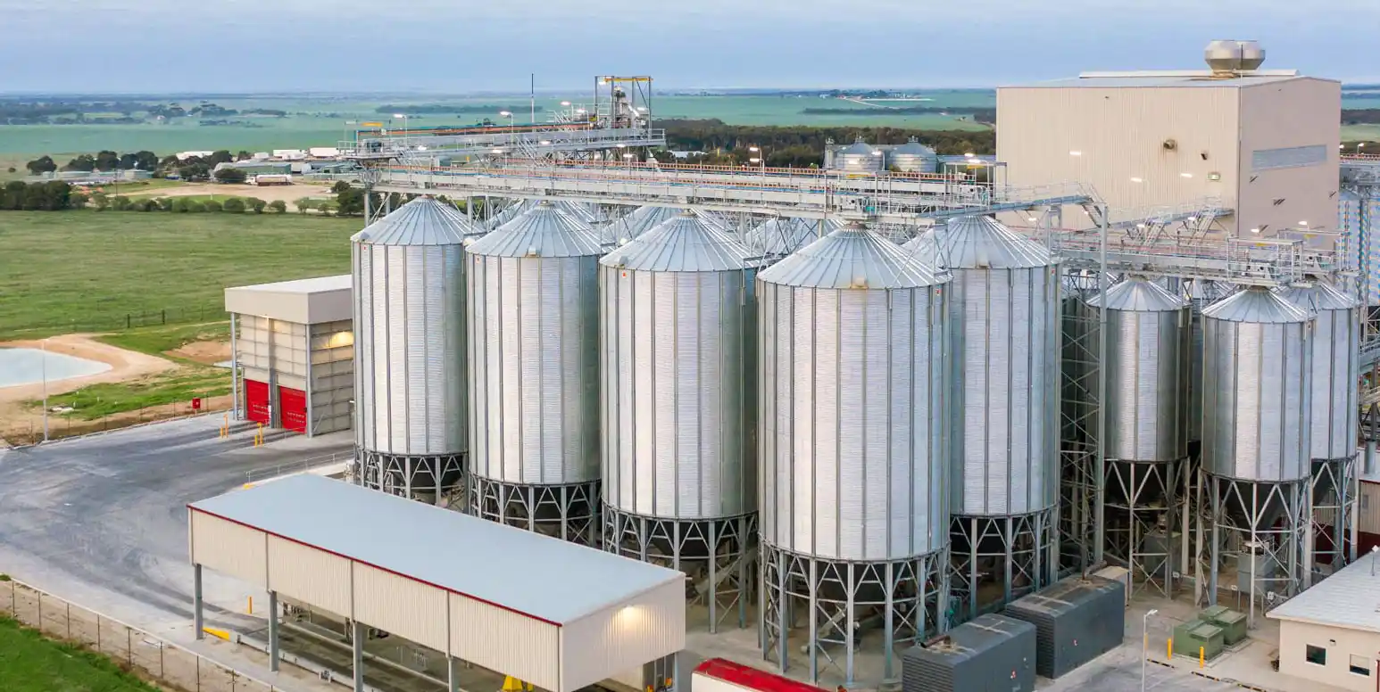 Galvanized steel grain silo battery with catwalks and handling towers at a grain terminal