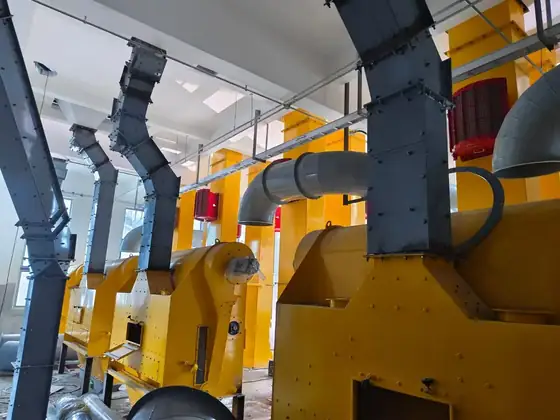 Yellow grain cleaning machines with spouting and aspiration ducting inside a mill building