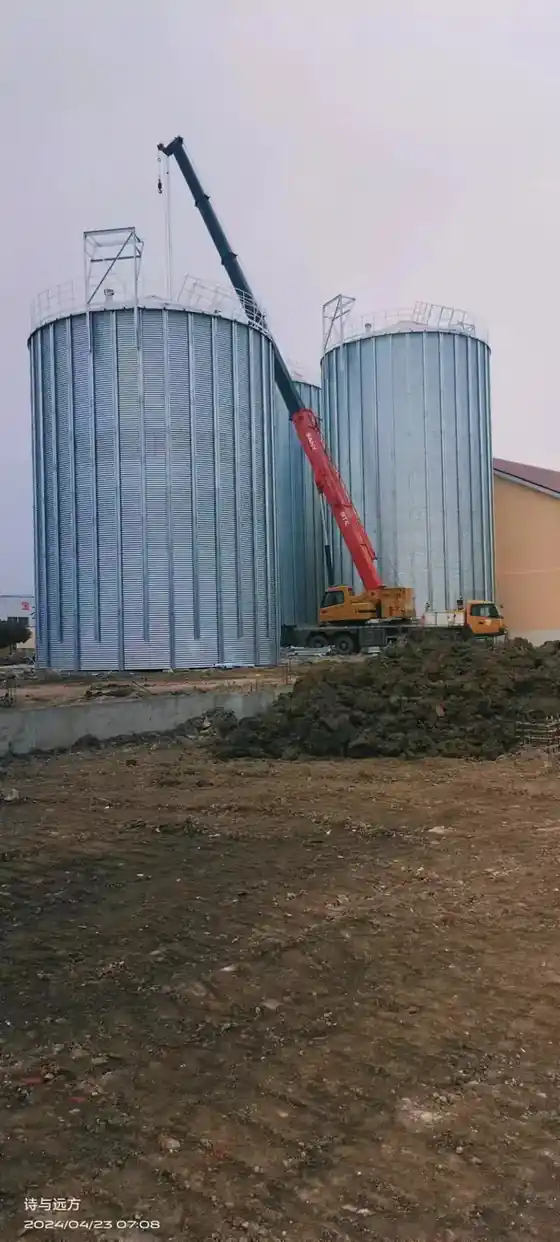 Assembled hopper bottom grain silo with corrugated shell and support legs