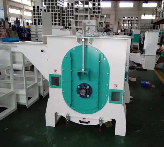 Rotary cleaning machine on the assembly floor with access panels open for inspection.