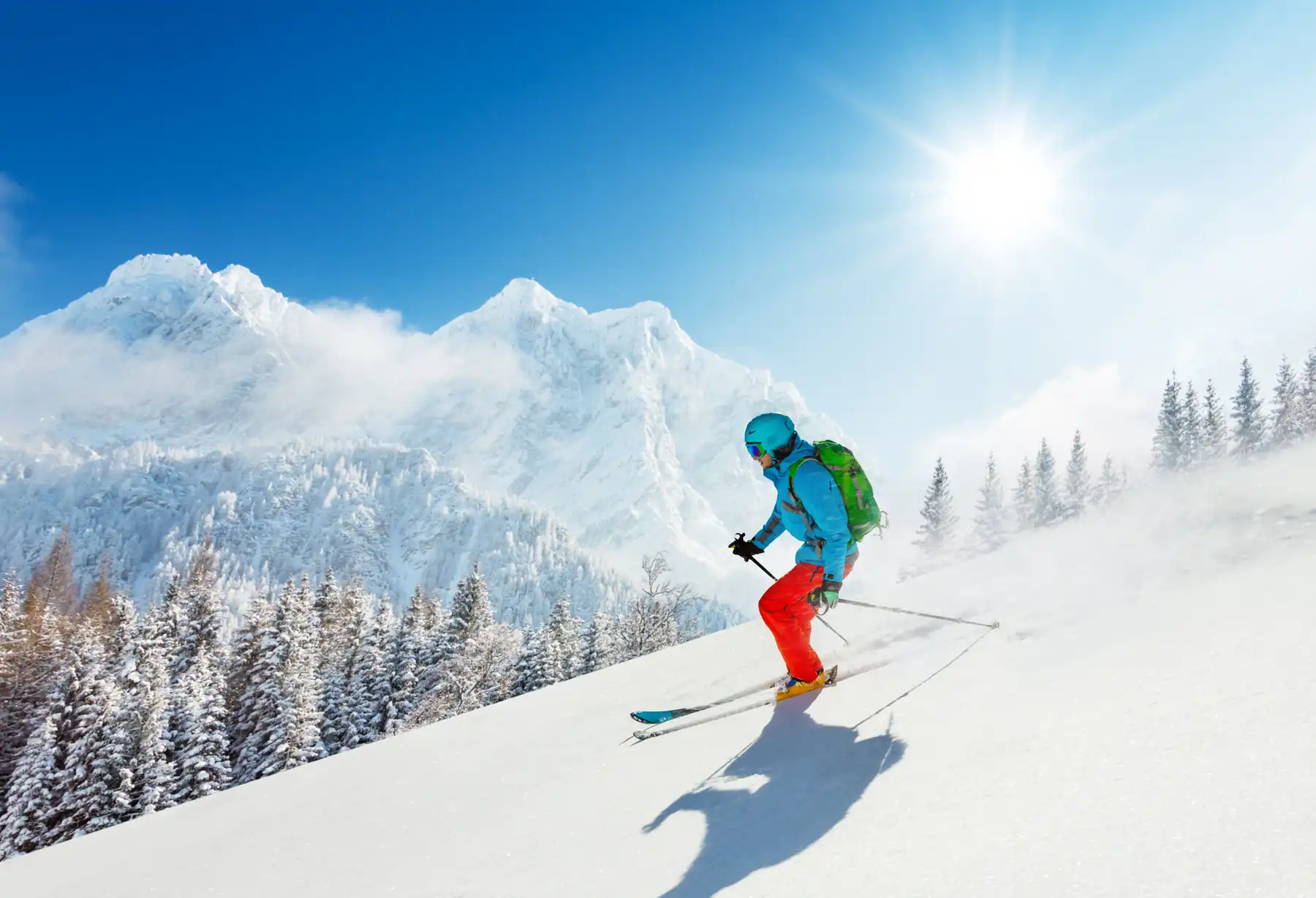 Skier on a groomed alpine slope