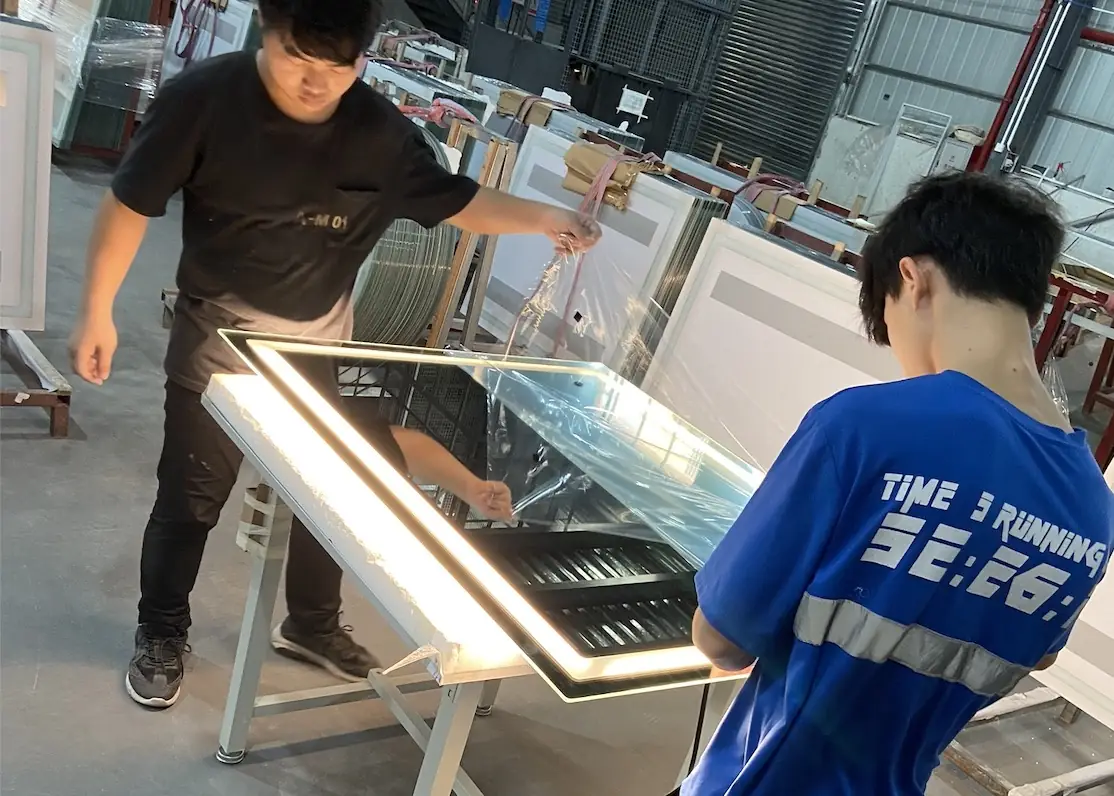 Inspecting each lighted mirror before assembly