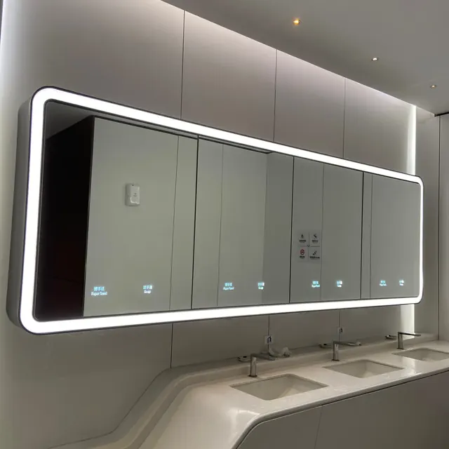 Airport washroom lighted mirror with integrated soap and towel dispensers