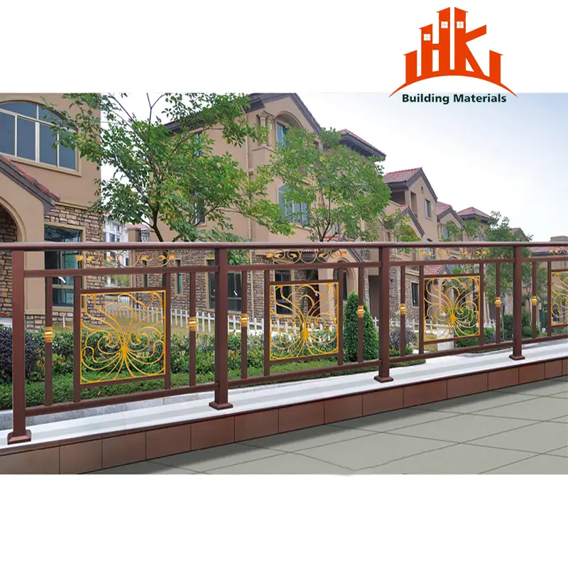 Brown and gold decorative metal balcony railing installed on a terrace with a residential building in the background.