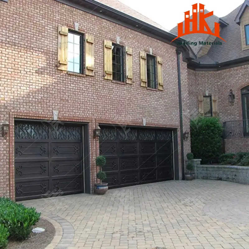 Two dark decorative carriage garage doors installed on a red brick house exterior