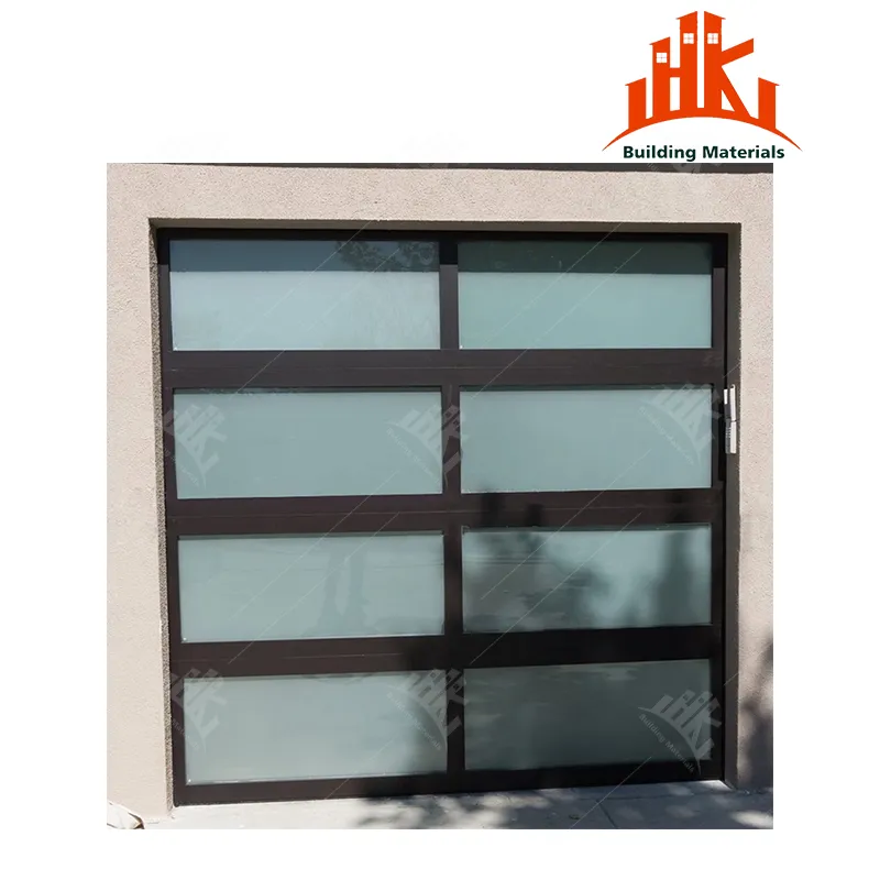 A modern sectional garage door featuring dark frames and frosted glass panels installed in a beige wall.