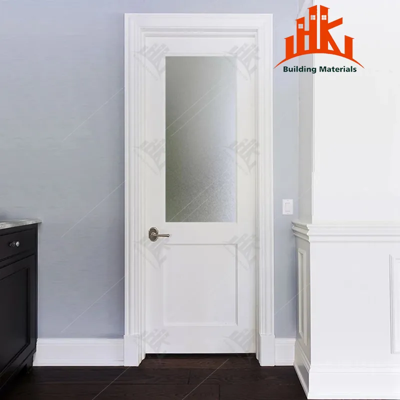 A white interior door with a tall frosted glass panel and silver handle in a room with grey walls.