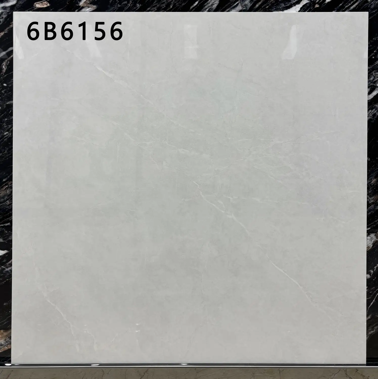 Light grey square floor tile with subtle marble veining and code 6B6156