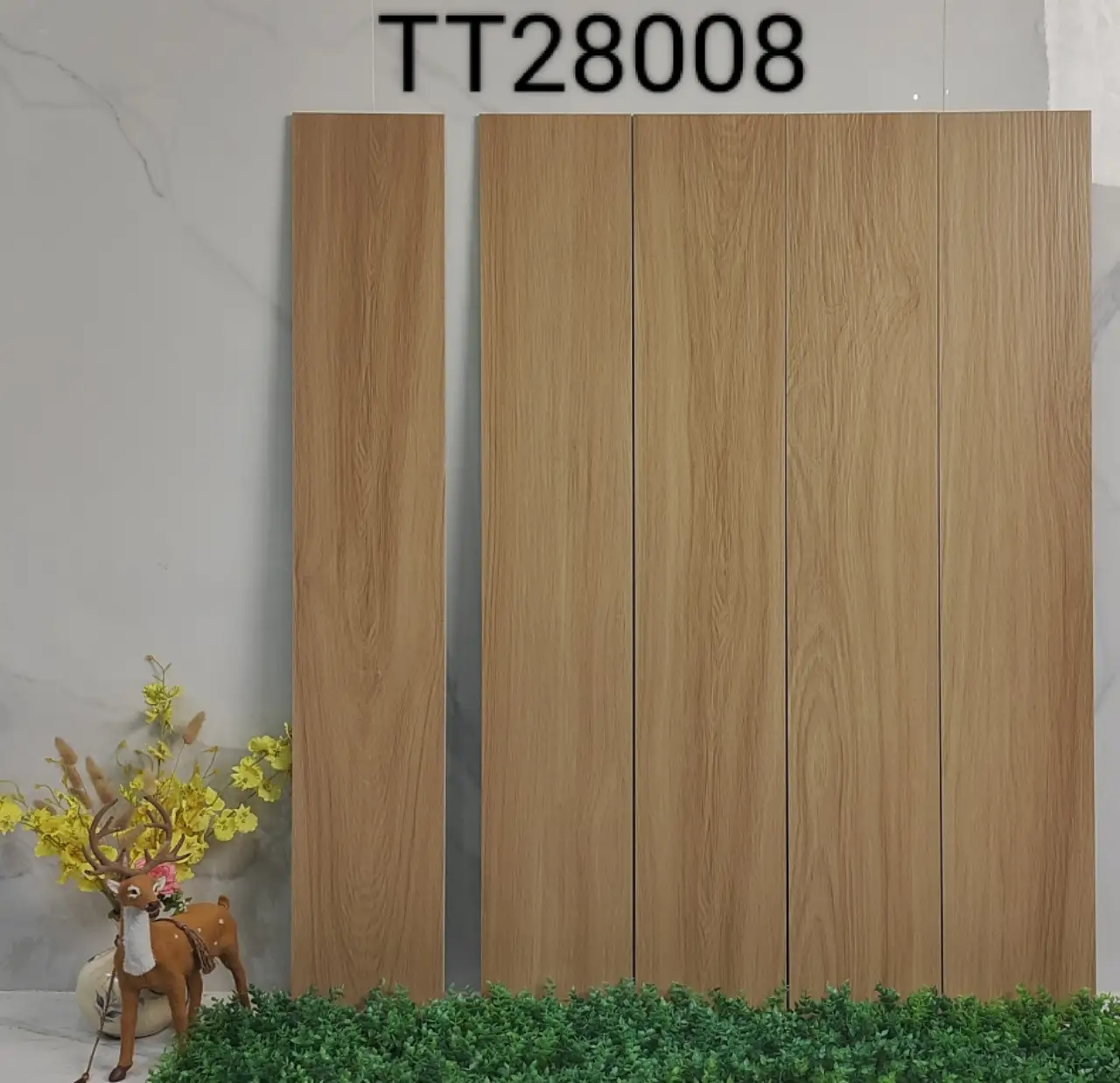 Vertical wood-look ceramic tiles arranged to form a wall panel, set against a marble background with floral decor.