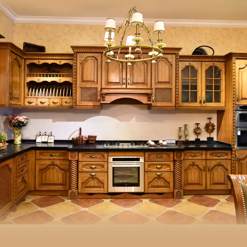 Luxury kitchen with wood cabinets, black countertops, and a chandelier