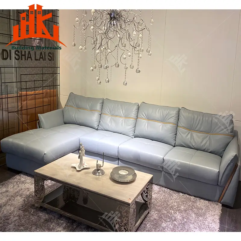 A modern living room featuring a light blue leather sectional sofa and coffee table