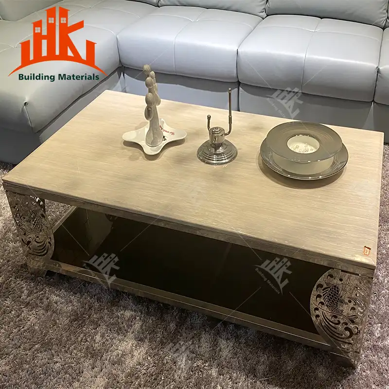 Gold mirrored coffee table with decorative side panels and glass top