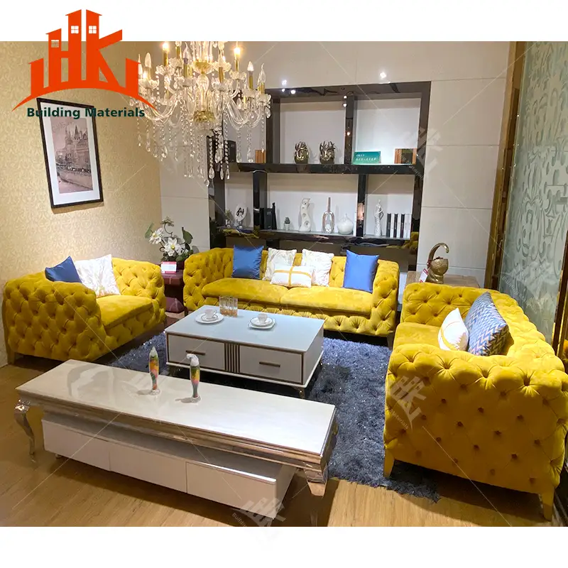 Living room with yellow tufted furniture and a crystal chandelier