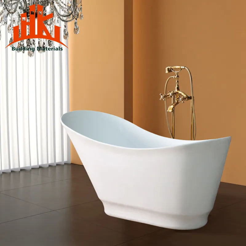 A modern white freestanding bathtub with a gold floor-mounted faucet.