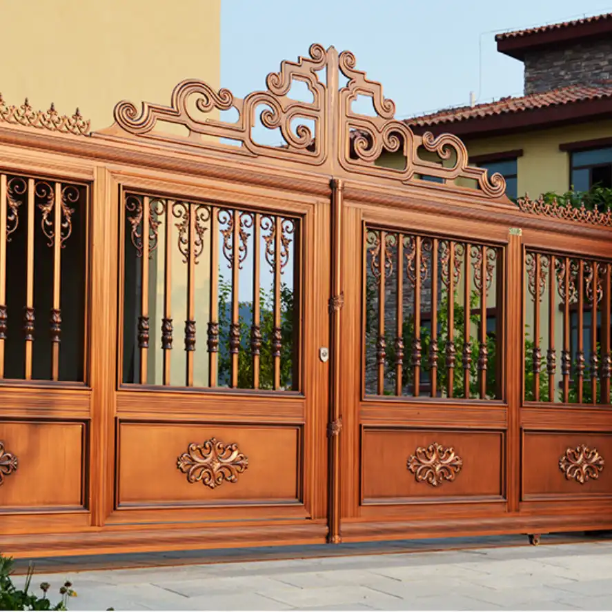 An ornate copper-colored metal gate with decorative scrollwork and vertical bars.