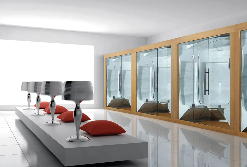 Modern minimalist lounge with red cushions and glass sauna room