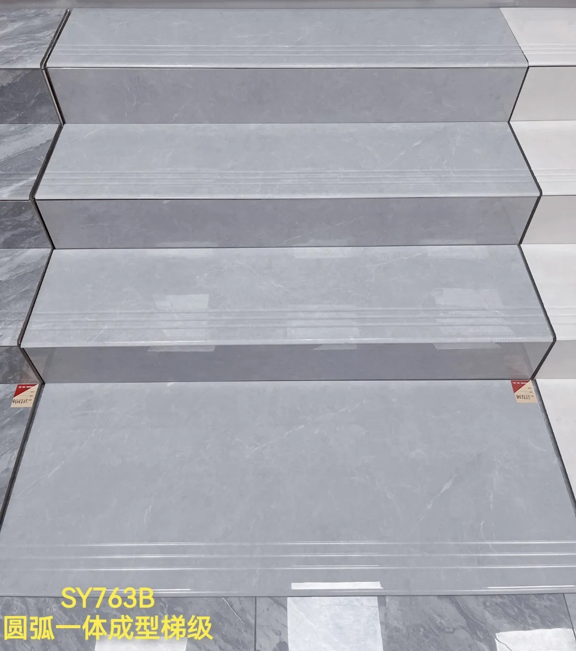 Grey marble-effect stair treads with rounded nosing and anti-slip grooves