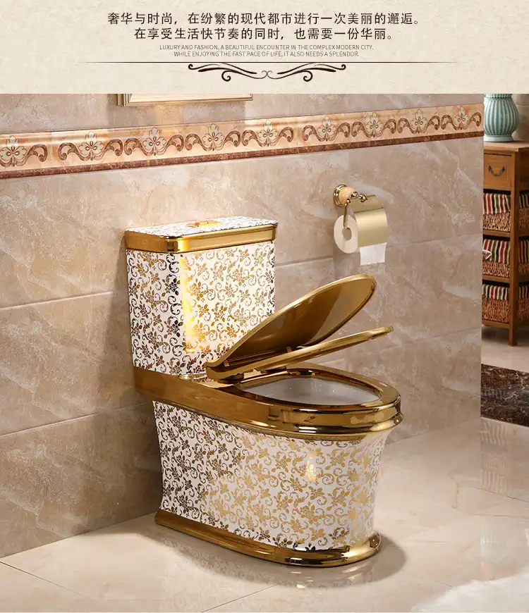 A white ceramic toilet decorated with an ornate gold floral pattern and gold trim.
