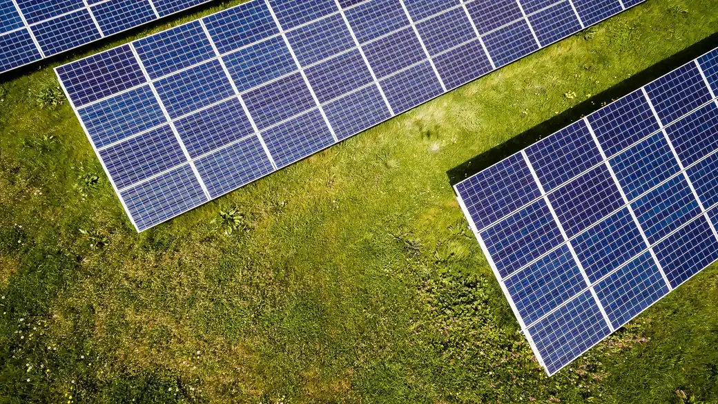 Aerial view of a utility-scale solar plant at sunrise