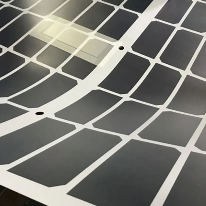 Grid-patterned transparent backsheet behind a cell string
