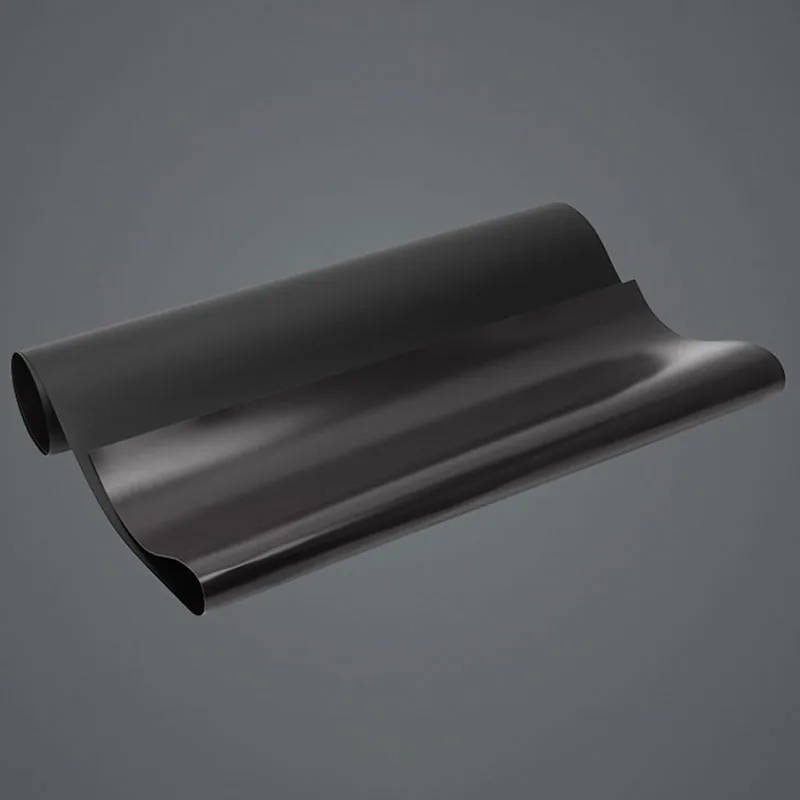 Black backsheet film with a white outer surface, partly rolled