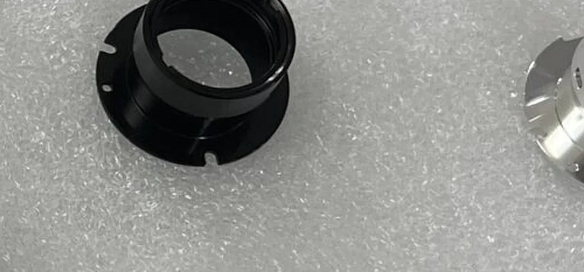 Machined aluminium tube clamps and connectors arranged on a light work surface