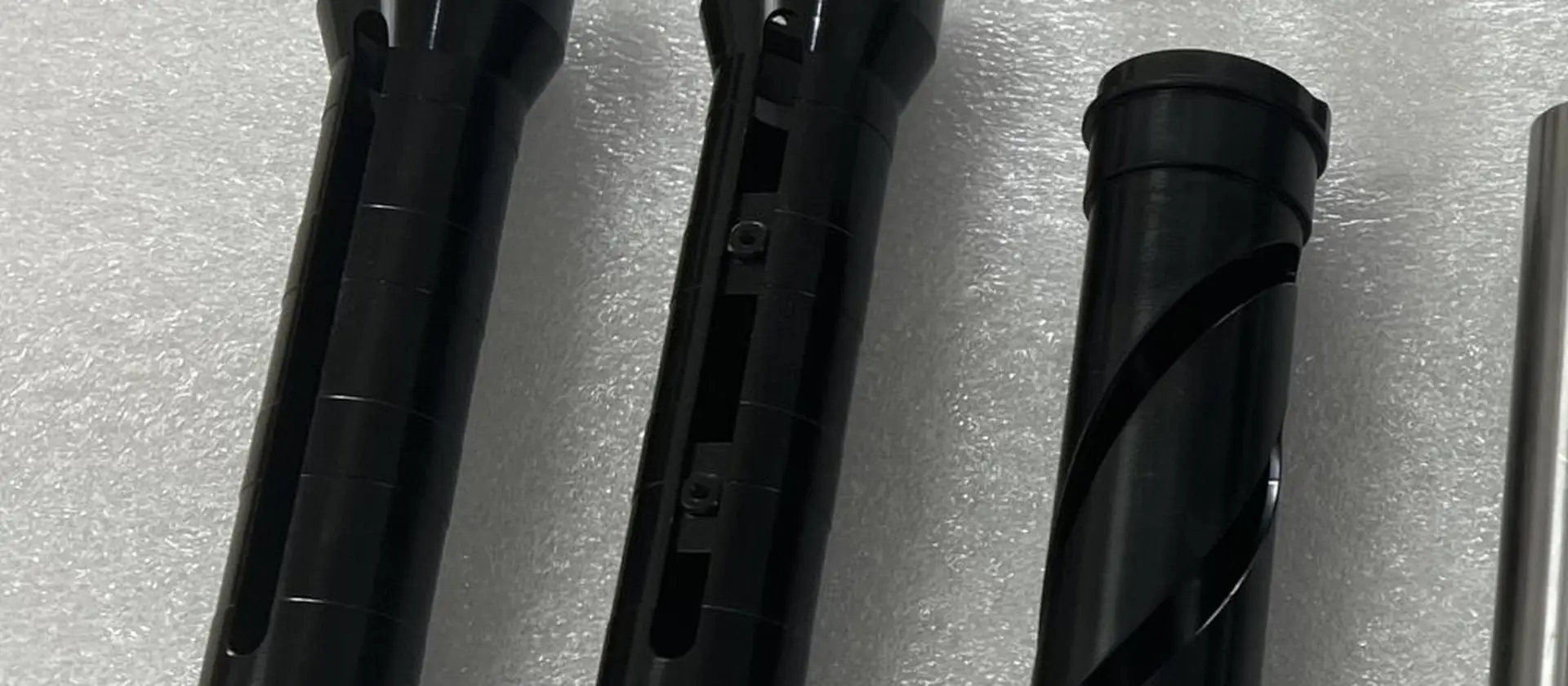 Anodised black machined housings and tube assemblies produced to customer drawings