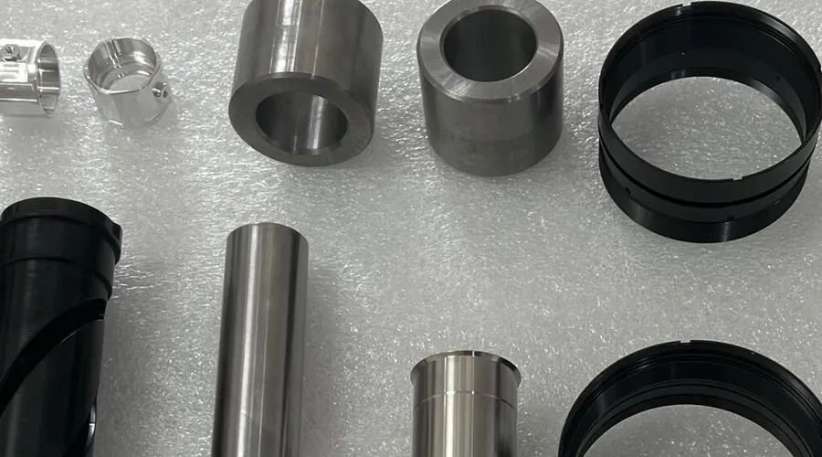Machined components shown in stainless steel and aluminium alongside each other