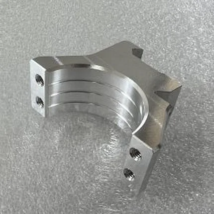 Machined aluminium split tube clamp with a slotted body and side fixing holes