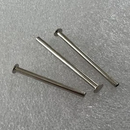 Three stainless steel headed pins with long plain shanks and formed heads