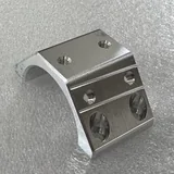 Machined aluminium saddle tube clamp with a curved seat and four counterbored fixing holes