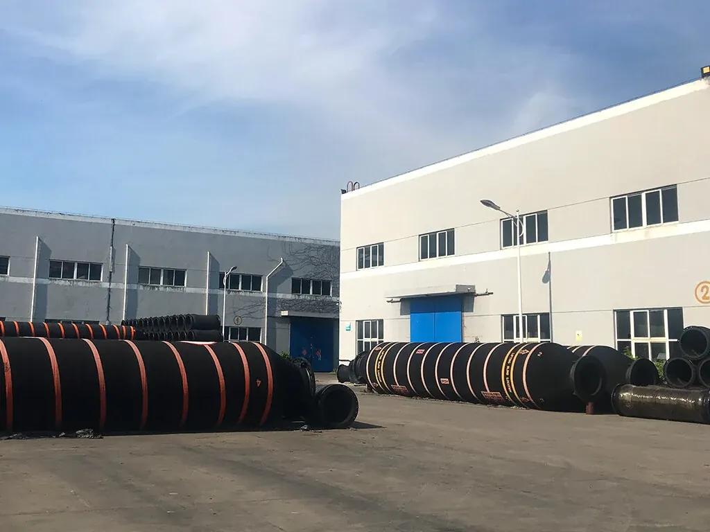 Large dredging hoses laid out in the East Marine factory yard before shipment