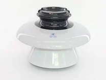 White ceramic electrical insulator with black ribbed top section on white background