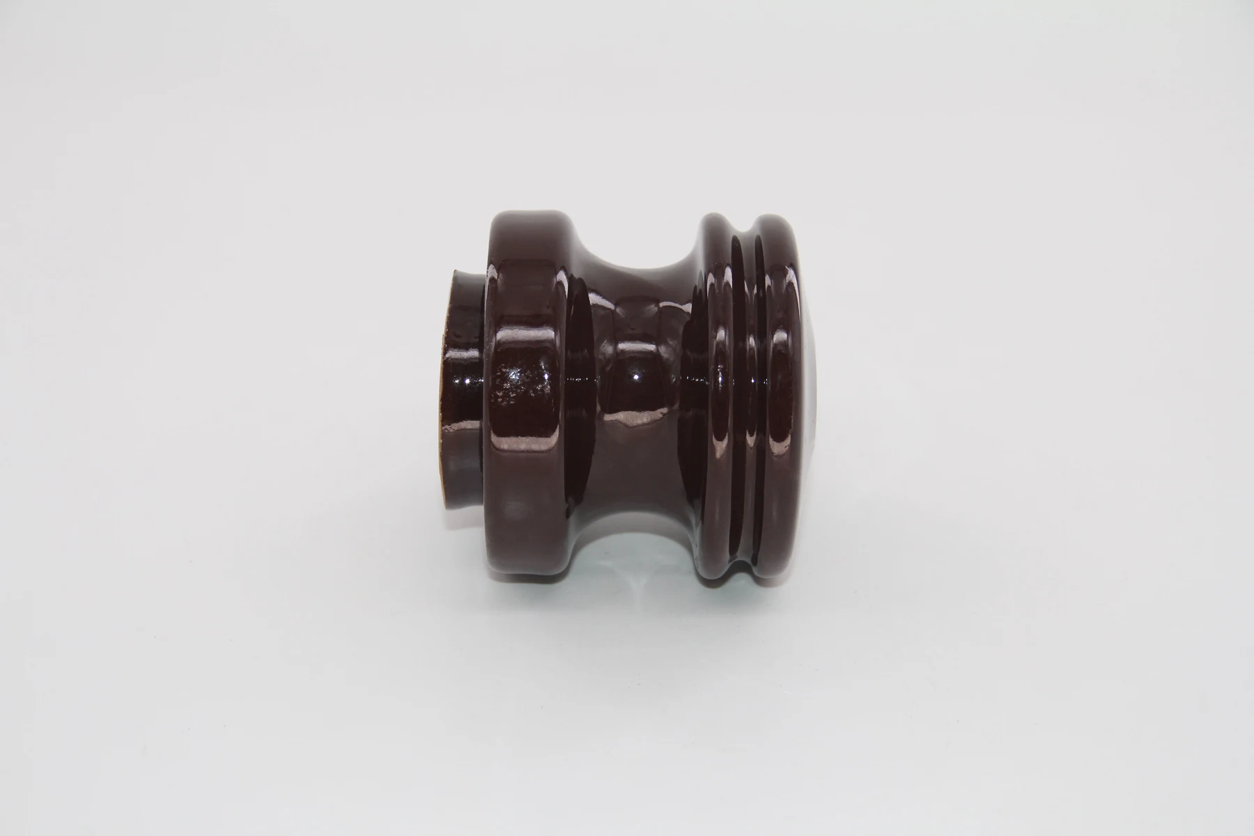 Bottom view of an ANSI 53-2 porcelain spool insulator showing the cemented base