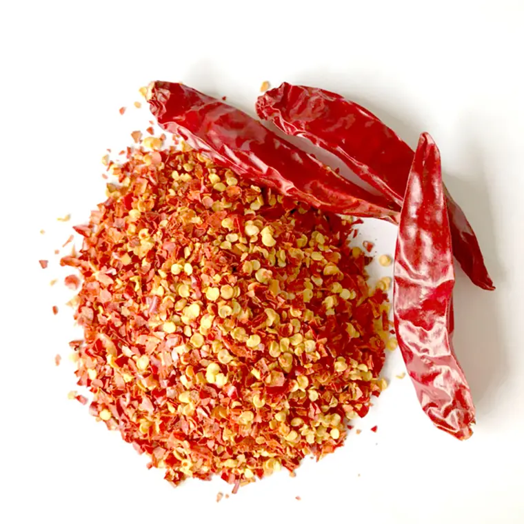 Crushed chili with seeds. The pale flecks are seed; the more of them in the cut, the light