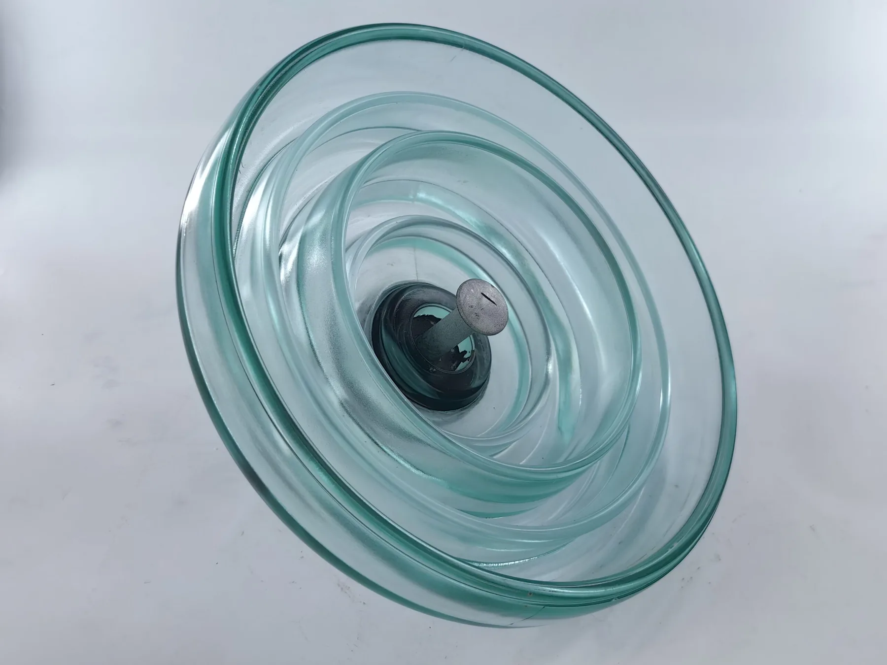 Fog type toughened glass insulator showing extended creepage path