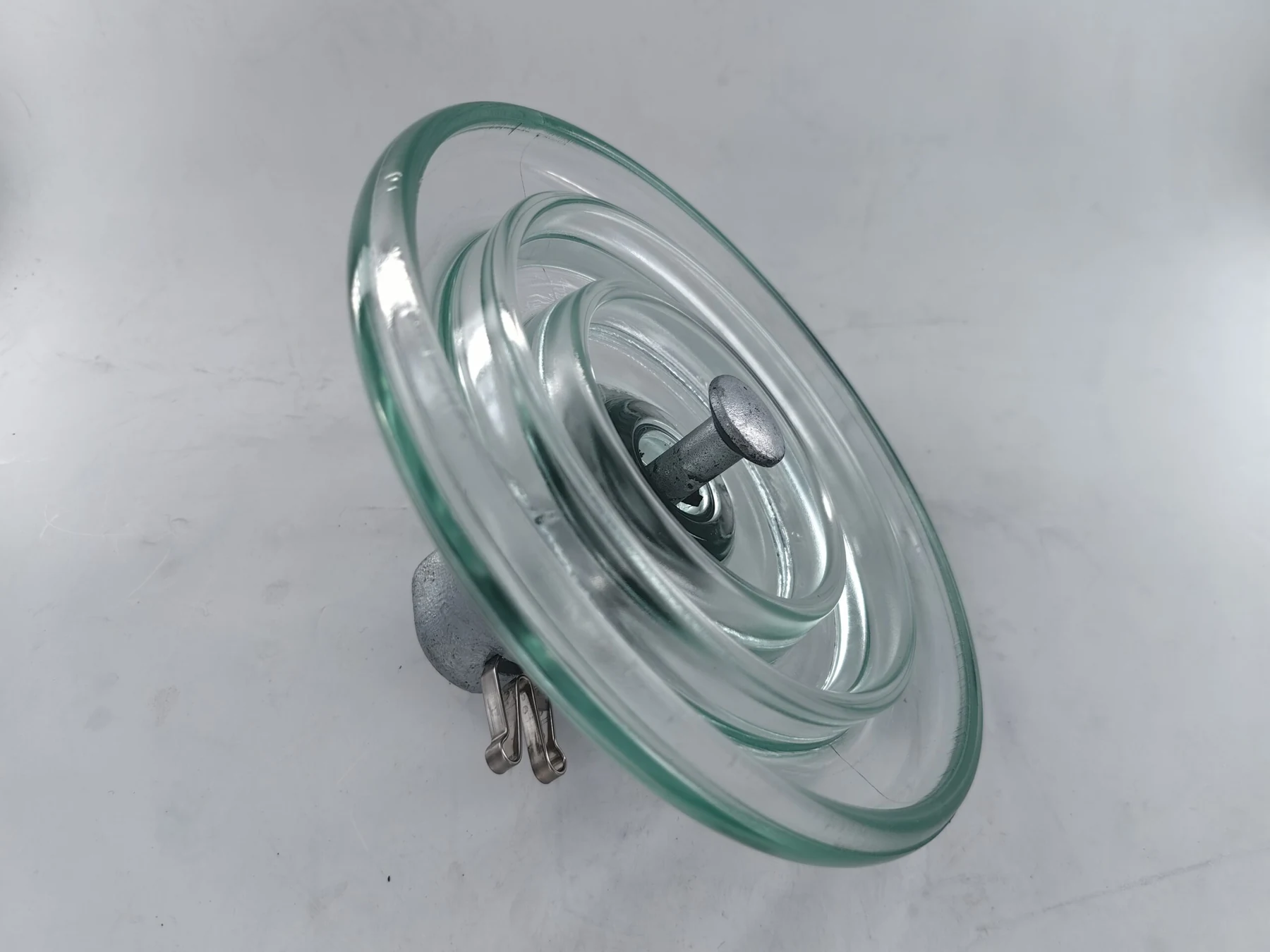 Toughened glass suspension insulator shell and galvanised cap